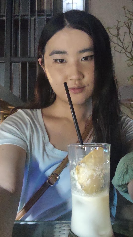 Me having a drink at a rooftop bar during happy hour